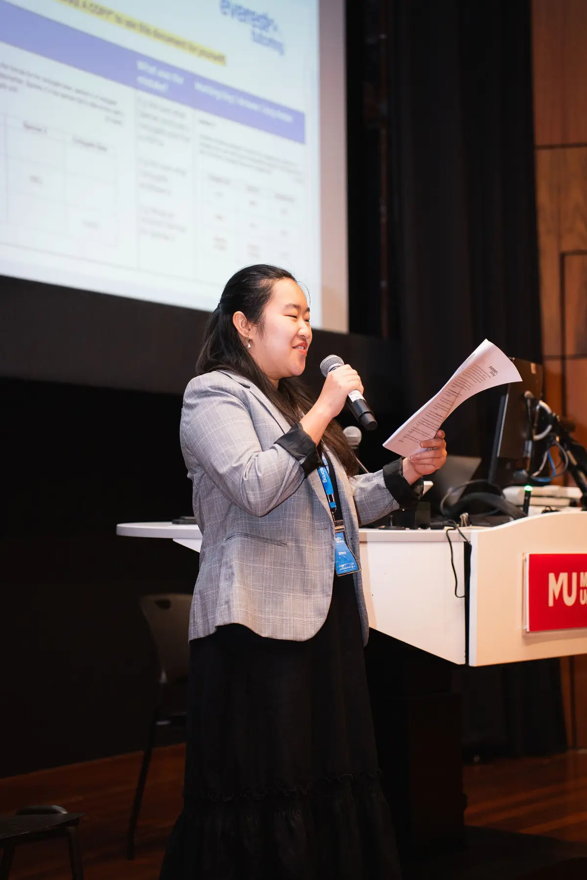 Everest tutor reading from her notes on stage