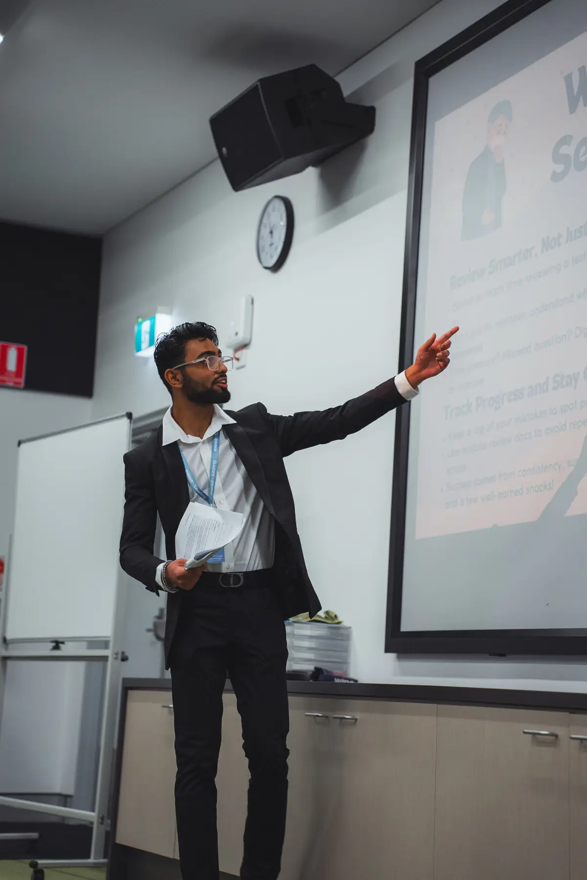 Everest tutor pointing to the whiteboard during a talk
