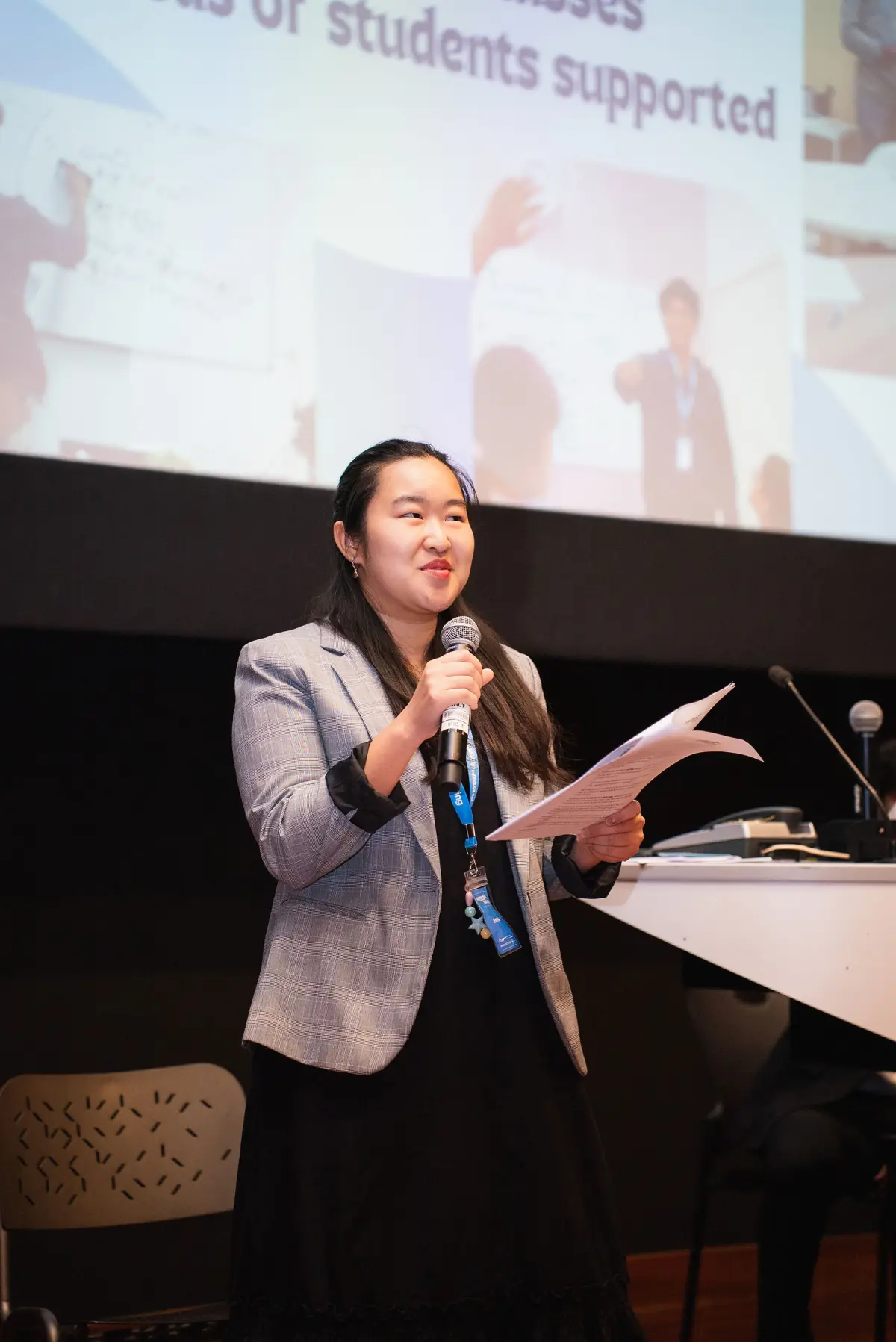 Everest tutor presenting with a microphone and notes