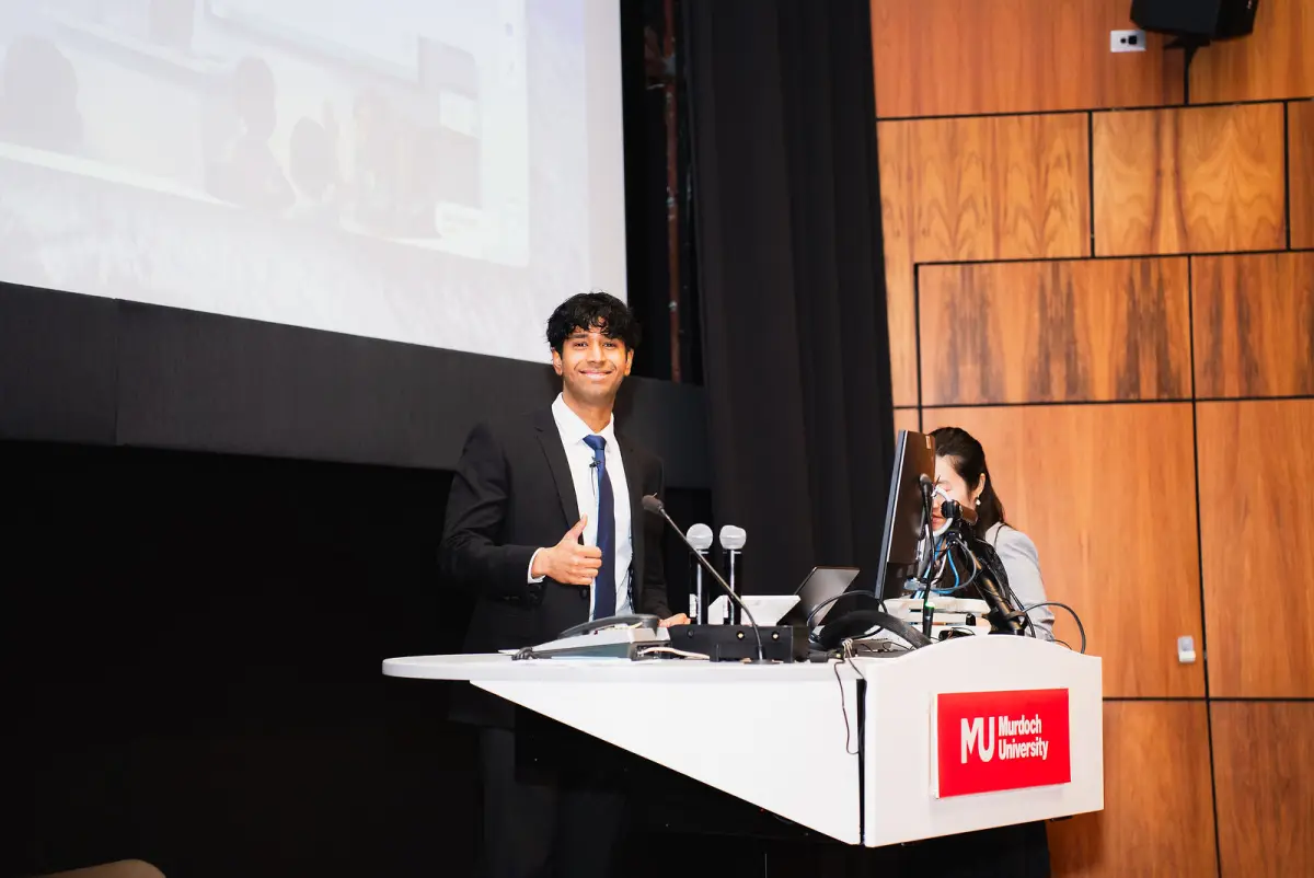 Everest tutor smiling at the lectern during the seminar