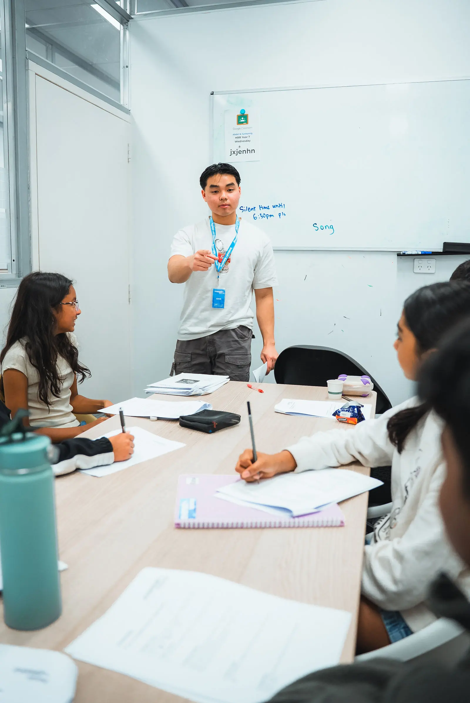 Everest tutor working an exam question on the whiteboard for a Year 12 class